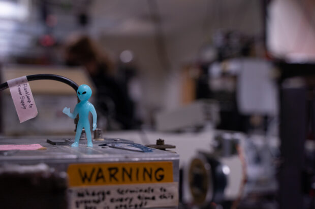 Alien figurine on top of the laser