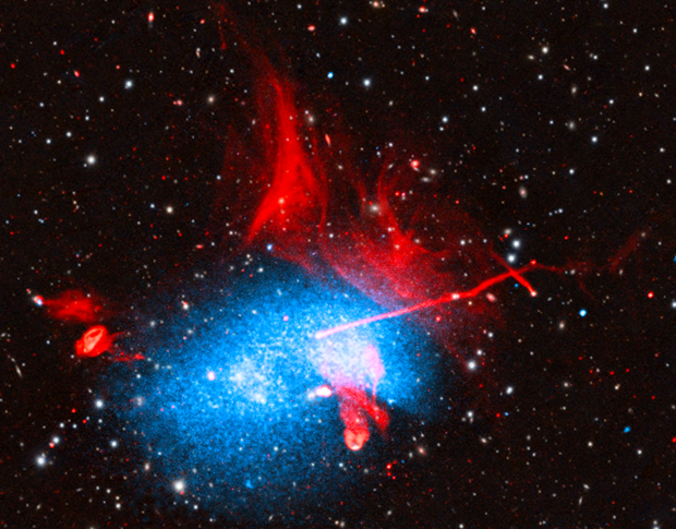 This release features a composite image of at least three galaxy clusters colliding in a jumbled scene. The resulting giant galaxy cluster, known as Abell 2256, resembles a grainy, pixilated, sky blue cloud topped with licks of flaming red hair. The cloud is adorned with red shapes and streaks, and set against a black background heavily dotted with colorful specks. The image combines X-ray, radio, optical, and infrared data. In this release, the composite image is presented both with, and without, labels. Near our lower left sits the oval-shaped, sky-blue cloud pixelated with white dots. This is the center of the combined galaxy cluster. The blue cloud shows enormous reservoirs of superheated gas, with temperatures of several million degrees Fahrenheit. Shooting out of the giant cluster, angled toward our upper-middle right, is a straight, thin red line labeled C. This is a jet; a stream of particles blasting away from a giant black hole. A second, much shorter jet, labeled I, crosses the tip of the first jet near the right hand side of the image. In the giant cluster, on the righthand side, are several irregular shapes. One, labeled A, resembles a bright white bean with a red outline. Beside it, labeled B, is a tangle of overlapping red shapes dangling out the bottom of the cloud. These are filaments, the result of jets interacting with gas. Three other irregular red filaments can be found to our left, just outside of the giant cluster. At the upper right hand edge of the oval-shaped giant cluster are sweeping sheets of red, which resemble lapping flames or licks of red hair. These relics are the results of shockwaves, likely generated by the collision of gas from the different clusters.