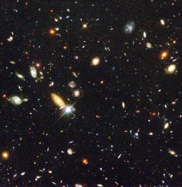 A deep space image of the central portion of the Hubble Deep Field depicting a cluster of galaxies.