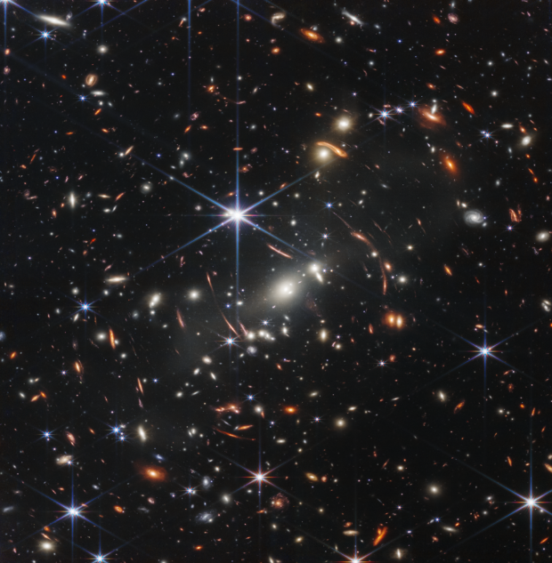 A deep space image of a cluster of galaxies, taken by the James Webb Space Telescope.